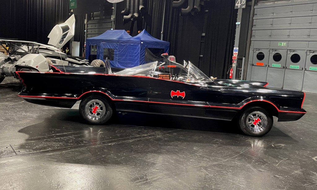 The 60s Batmobile parked in a convention hall